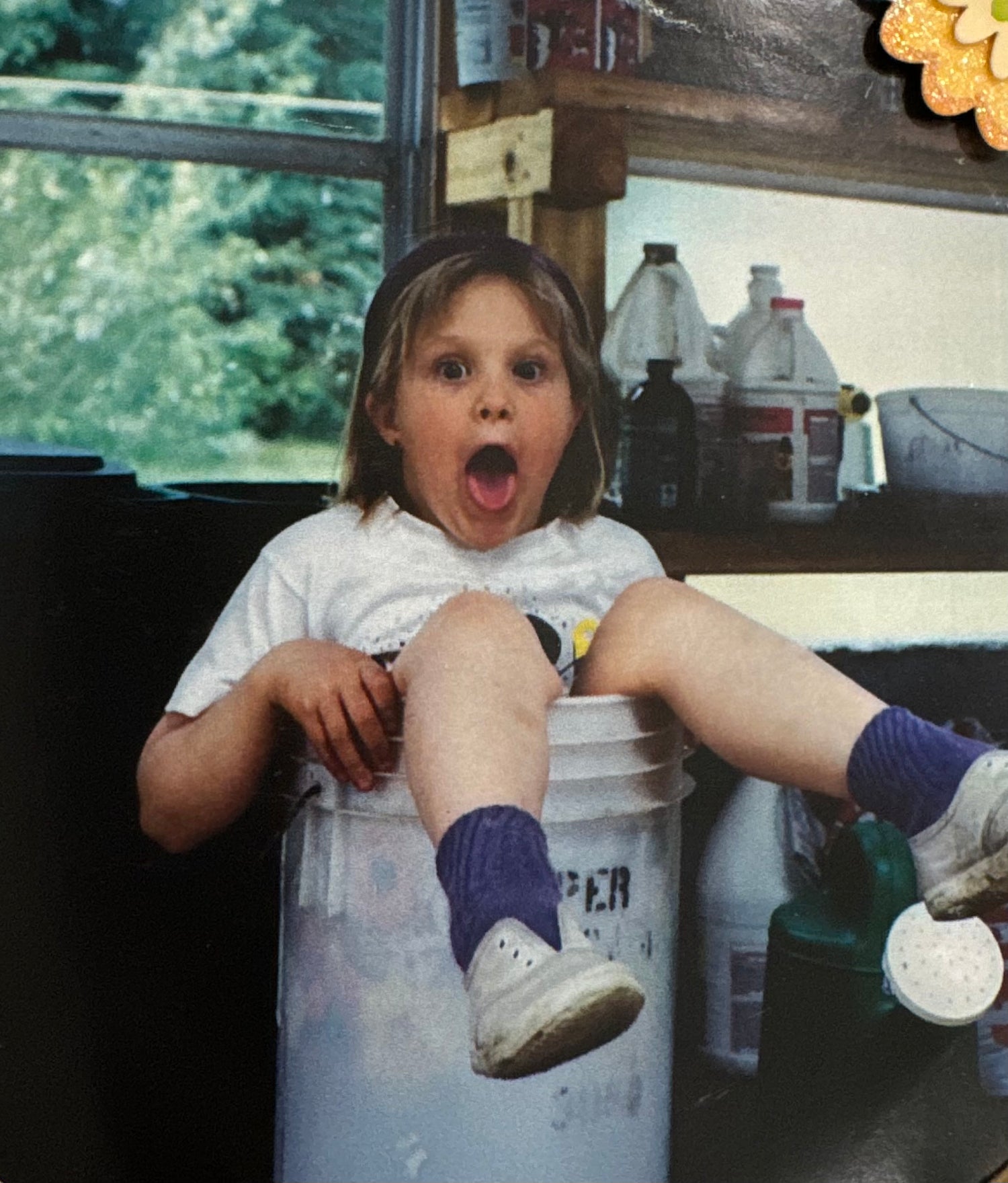 baby girl sitting in bucket